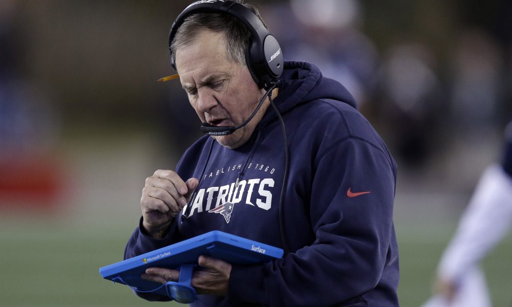 New England Patriots head coach Bill Belichick studies a tablet device along the sideline during the first half of an NFL football game against the Philadelphia Eagles, Sunday, Dec. 6, 2015, in Foxborough, Mass. (AP Photo/Charles Krupa) ORG XMIT: FBO117